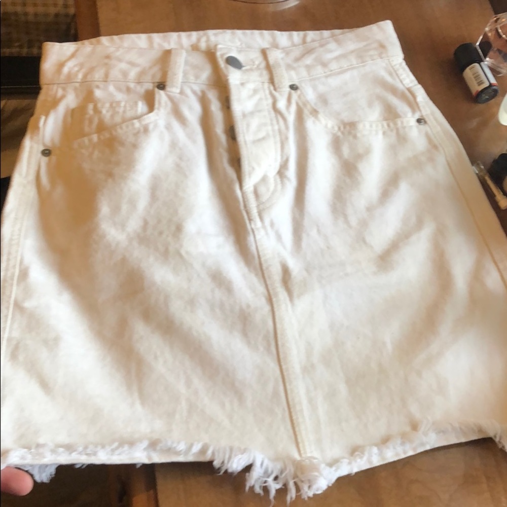 White denim skirt with frayed hem.